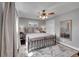 Comfortable primary bedroom with ceiling fan, gray walls, and mirror in bedroom at 9225 Lowell Blvd, Westminster, CO 80031