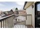 View from balcony featuring wood railing, view of neighboring townhomes, and a bright setting at 130 S Holman Way, Golden, CO 80401