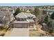 Stunning aerial view of a home showcasing its tile roof, three-car garage, and landscaping at 6584 S Sedalia St, Aurora, CO 80016