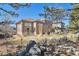 Spacious backyard view showcasing the multi-story home, landscaping, and patio furniture at 6584 S Sedalia St, Aurora, CO 80016