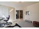 Unfinished basement space with large sliding glass doors, a small window, and electric baseboard heater at 6584 S Sedalia St, Aurora, CO 80016