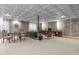 Spacious basement living area featuring exposed concrete walls and stylish decor, perfect for relaxation and entertainment at 6584 S Sedalia St, Aurora, CO 80016