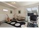 Well-lit basement space designed for musical pursuits, features a guitar, keyboard, and workstation at 6584 S Sedalia St, Aurora, CO 80016