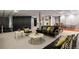 The finished basement boasts a lounge area with an entertainment center and unique ceiling tile at 6584 S Sedalia St, Aurora, CO 80016