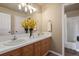 Bathroom with dual sinks, a vanity, and a separate shower at 6584 S Sedalia St, Aurora, CO 80016