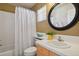 Cozy bathroom featuring a tub, toilet, large vanity and decorative mirror at 6584 S Sedalia St, Aurora, CO 80016