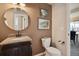Elegant half-bathroom featuring granite countertop, framed art, and adjacent dining area at 6584 S Sedalia St, Aurora, CO 80016
