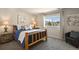 Cozy bedroom featuring a log-style bed frame, plush carpet, and a sunny window with neighborhood views at 6584 S Sedalia St, Aurora, CO 80016