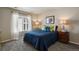 Bright bedroom with colorful pillows and art, a large window, and side tables with lamps at 6584 S Sedalia St, Aurora, CO 80016