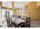Dining room featuring a long table, large windows, and elegant chandelier at 6584 S Sedalia St, Aurora, CO 80016