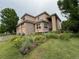 Attractive two-story home with well-manicured lawn, a three car garage, and mature trees at 6584 S Sedalia St, Aurora, CO 80016