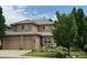 Charming two-story home with a neutral color scheme, well-maintained lawn and three car garage at 6584 S Sedalia St, Aurora, CO 80016