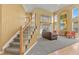 Staircase leading to spacious living room with large windows at 6584 S Sedalia St, Aurora, CO 80016
