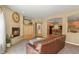 Spacious living room with fireplace, plush furniture, and an open layout at 6584 S Sedalia St, Aurora, CO 80016
