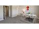 Home office with glass desk, comfortable chair, carpeted floor and lots of light at 6584 S Sedalia St, Aurora, CO 80016