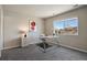 Home office with a modern glass desk, neutral decor, and a large window with views of the neighborhood at 6584 S Sedalia St, Aurora, CO 80016