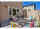 Inviting outdoor patio with colorful seating around a fire table, perfect for gatherings and relaxation at 6584 S Sedalia St, Aurora, CO 80016