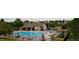Community pool and clubhouse featuring an outdoor pool, covered seating areas, and plenty of lounge chairs at 6584 S Sedalia St, Aurora, CO 80016