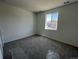 Cozy bedroom featuring new carpeting and a bright window at 6658 N Nepal Ct, Aurora, CO 80019