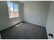 Bedroom with plush carpeting and a window overlooking the neighborhood at 6658 N Nepal Ct, Aurora, CO 80019