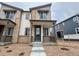 Charming two-story townhome featuring stone accents, a covered porch, and a well-maintained front yard at 6658 N Nepal Ct, Aurora, CO 80019