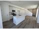 Bright, open kitchen featuring an island, modern appliances, and white cabinetry at 6658 N Nepal Ct, Aurora, CO 80019
