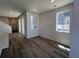 Bright living room with hardwood floors, large windows, and ample natural light at 6658 N Nepal Ct, Aurora, CO 80019