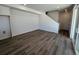 Spacious living area with hardwood floors, staircase, and adjacent closet space at 6658 N Nepal Ct, Aurora, CO 80019