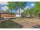 A spacious backyard featuring a detached garage and a covered patio area at 1023 S Alcott St, Denver, CO 80219