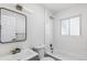 White bathroom featuring a shower over tub, a new vanity with modern fixtures, and a large mirror at 1023 S Alcott St, Denver, CO 80219