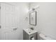 This is a bright bathroom with a new vanity, mirror, updated fixtures, and a new toilet at 1023 S Alcott St, Denver, CO 80219