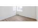 Bedroom with a neutral color palette, new flooring, and a large window at 1023 S Alcott St, Denver, CO 80219