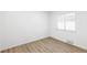 Bright bedroom featuring new vinyl floors, neutral paint, and a large window at 1023 S Alcott St, Denver, CO 80219
