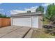 Detached garage with a white door and matching side entrance at 1023 S Alcott St, Denver, CO 80219