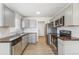 Well-equipped kitchen featuring stainless steel appliances and gray cabinetry at 1023 S Alcott St, Denver, CO 80219