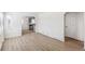 Bright living room with hardwood floors and a view into the adjacent kitchen at 1023 S Alcott St, Denver, CO 80219