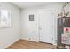 View of the utility room featuring a new water heater, fresh paint, and a new vinyl floor at 1023 S Alcott St, Denver, CO 80219