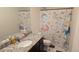 Charming bathroom featuring decorative unicorn themed shower curtain, toilet seat, and floor mat at 47375 Lilac Ave, Bennett, CO 80102