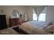 Cozy bedroom boasts a queen-size bed and matching dressers with a sleek black rug at 47375 Lilac Ave, Bennett, CO 80102