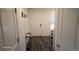 Welcoming entryway features wood-look floors, neutral paint, and access to the rest of the home at 47375 Lilac Ave, Bennett, CO 80102