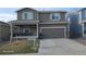 Charming two-story home features a covered porch, neutral siding, and attached two-car garage at 47375 Lilac Ave, Bennett, CO 80102
