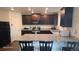 Well-lit kitchen features granite countertops, wood cabinets, and stainless steel appliances at 47375 Lilac Ave, Bennett, CO 80102