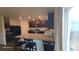 Open concept kitchen features granite countertops, wood cabinets, and stainless steel appliances at 47375 Lilac Ave, Bennett, CO 80102