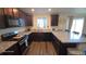 Spacious kitchen offers granite countertops, wood cabinets, and stainless steel appliances at 47375 Lilac Ave, Bennett, CO 80102