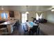 Open concept living space features plush furniture, a ceiling fan, and access to the backyard at 47375 Lilac Ave, Bennett, CO 80102