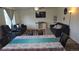 Spacious living room features plush furniture, a ceiling fan and built-in shelving at 47375 Lilac Ave, Bennett, CO 80102