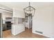 Open kitchen and dining space with a quartz island, modern pendant lighting, and stainless steel appliances at 1620 S Ivory Cir # C, Aurora, CO 80017