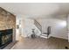 Bright living room with a cozy fireplace, wood floors, and staircase at 1620 S Ivory Cir # C, Aurora, CO 80017