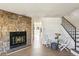 Inviting living room featuring a fireplace, stairs, and light wood-look floors at 1620 S Ivory Cir # C, Aurora, CO 80017