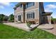 The backyard patio offers an outdoor dining area and easy access to the green lawn at 13322 Meadow Park Ln, Broomfield, CO 80020